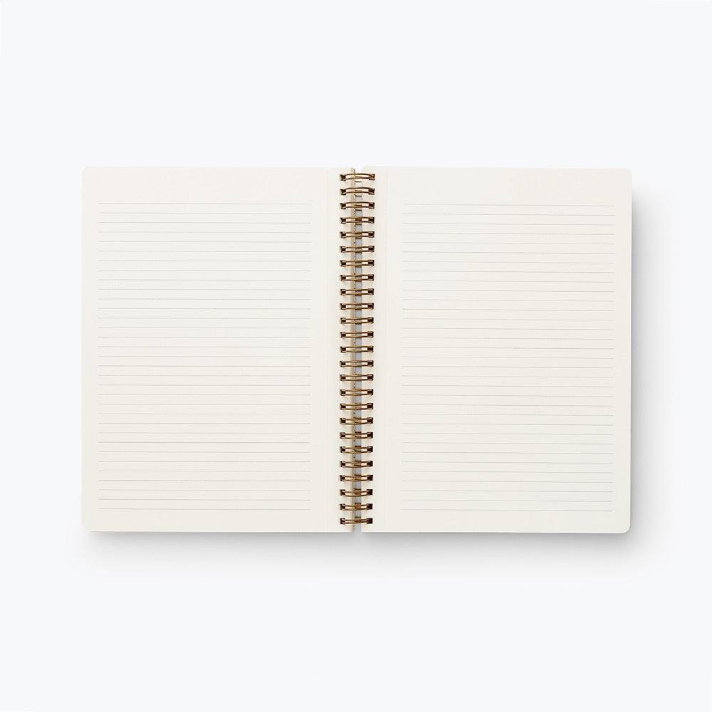 Libreta Colette A5 abierta, páginas rayadas, espiral dorada, diseño elegante.