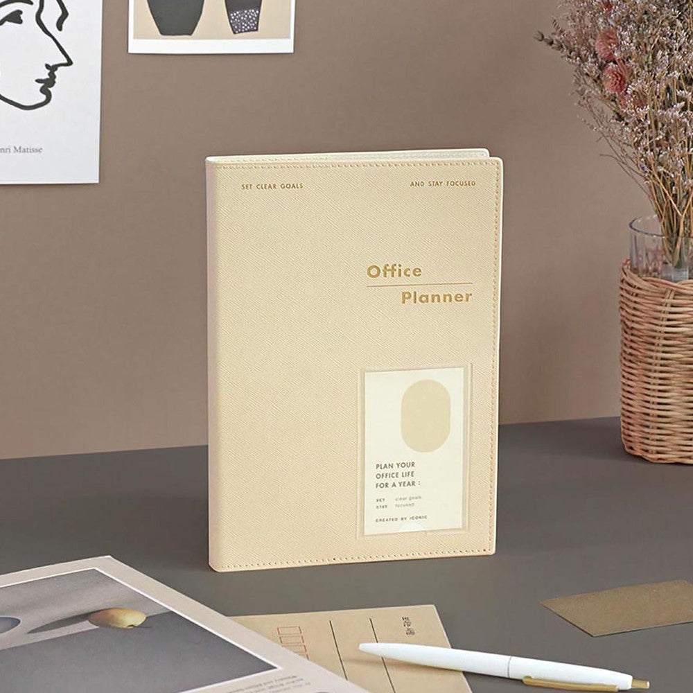 Office Planner ICONIC Ivory with PVC cover on desk surrounded by stationery items