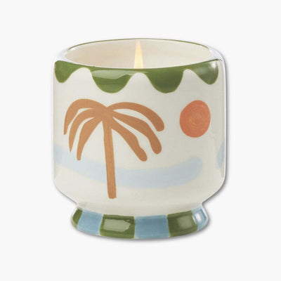 vela perfumada paddywax en recipiente de cerámica pintada con palmeras