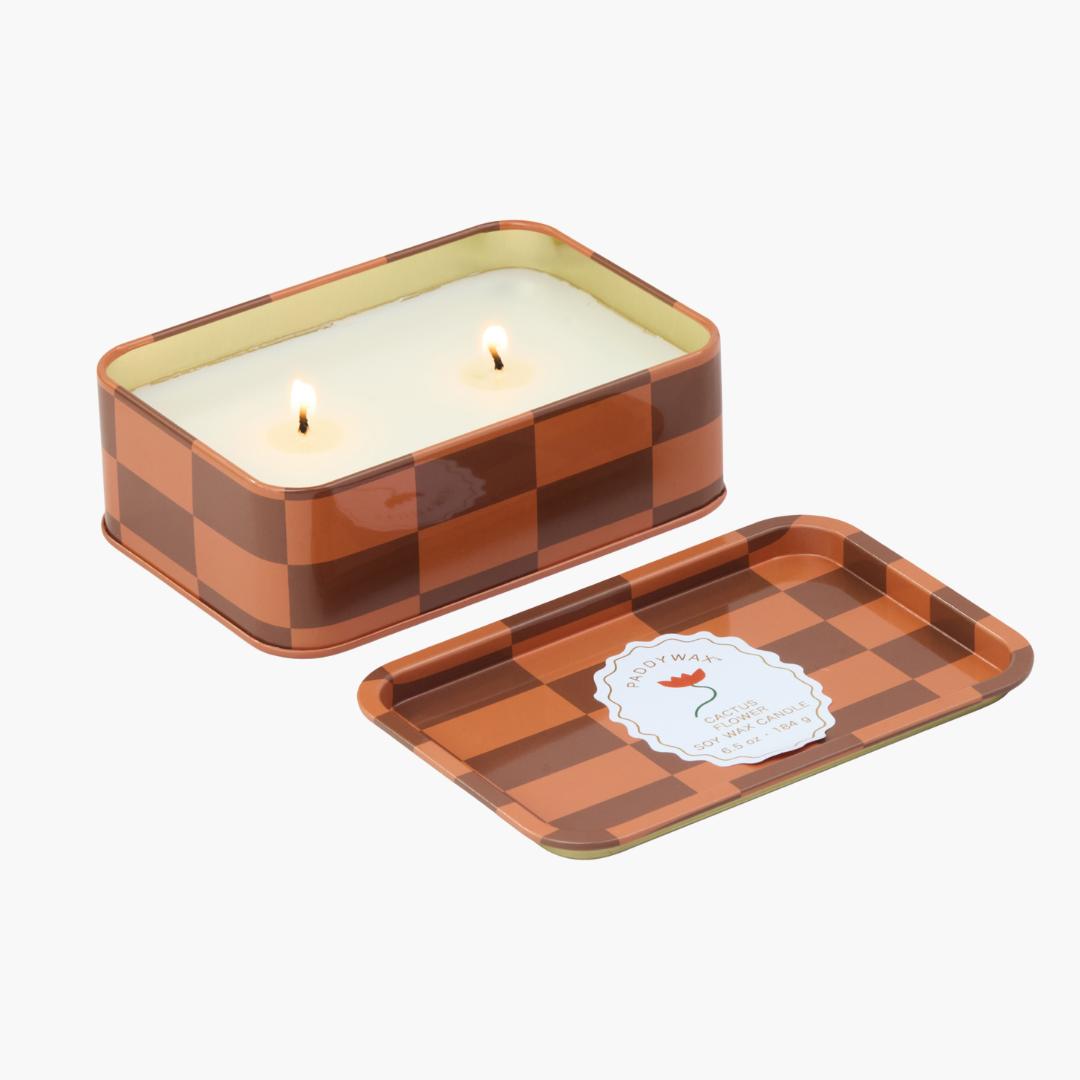 lata con vela con diseño de cuadros en colores naranjas