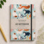 Cuaderno A5 Alljoy Design Curious Cats con gatos de colores sobre fondo azul claro