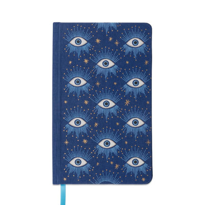 portada de cuaderno con tapa entelada en color azul con diseño de ojos sobre cielo estrellado