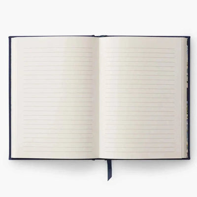 Diario personal en tela bordada con páginas pautadas y cinta marca páginas.