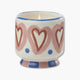 vela perfumada paddywax en recipiente de cerámica pintada con corazones